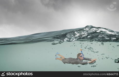 Businesswoman diver in mask. Young businesswoman in suit and diving mask swimming under water