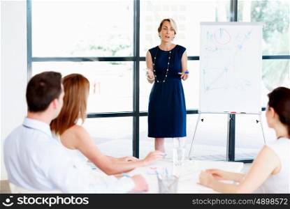 Businesswoman doing a presentaion in front of her collegues