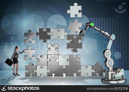 Businesswoman doing jigsaw puzzle with robotic arm