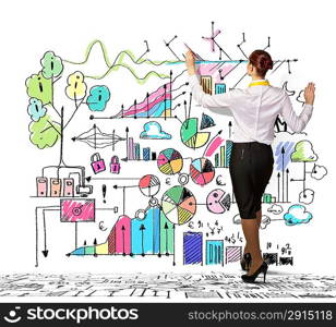 Businesswoman drawing on wall