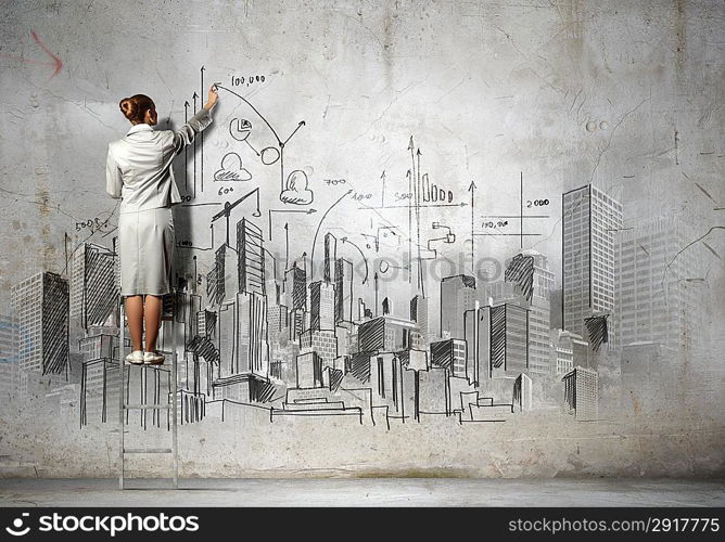 Businesswoman drawing on wall