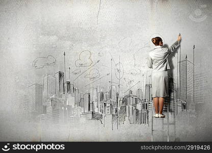 Businesswoman drawing on wall