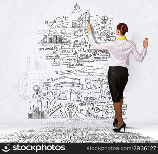 Businesswoman drawing on wall