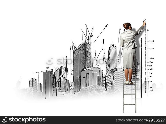 Businesswoman drawing on wall
