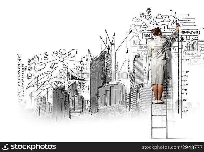 Businesswoman drawing on wall