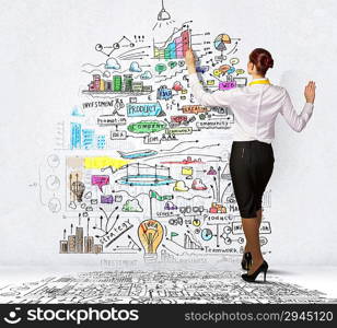 Businesswoman drawing on wall