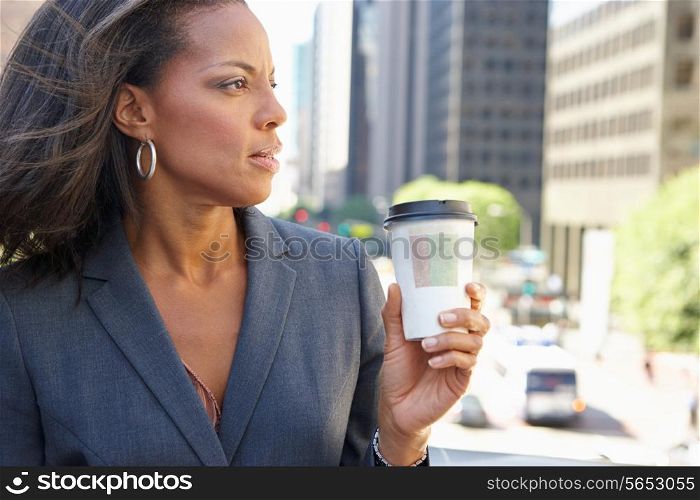 Businesswoman Drinking Takeaway Coffee Outside Office