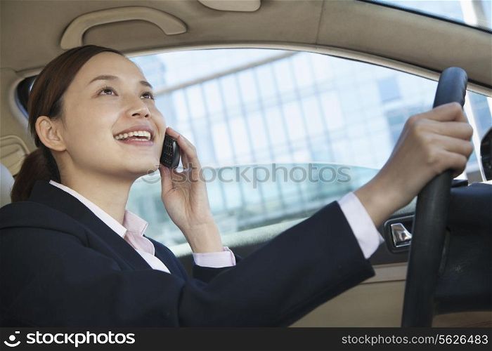 Businesswoman Driving and On the Phone in Beijing