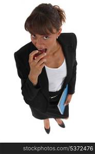 Businesswoman eating apple