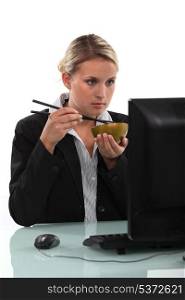 Businesswoman eating Chinese food