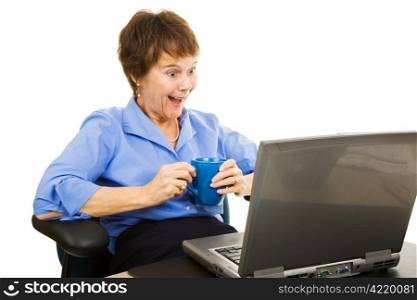 Businesswoman enjoys what she&rsquo;s reading on her computer. Isolated on white.