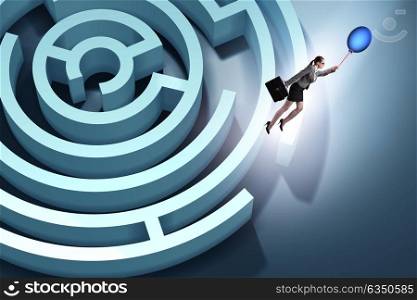 Businesswoman escaping from maze on balloon