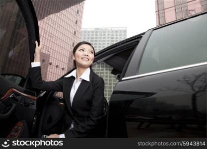 Businesswoman exiting a car
