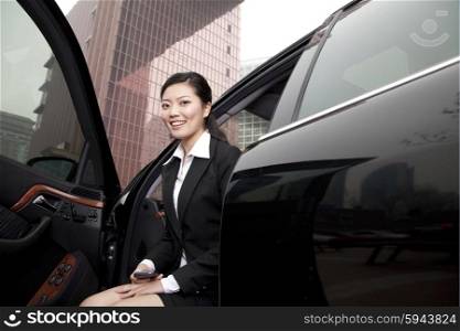 Businesswoman exiting a car