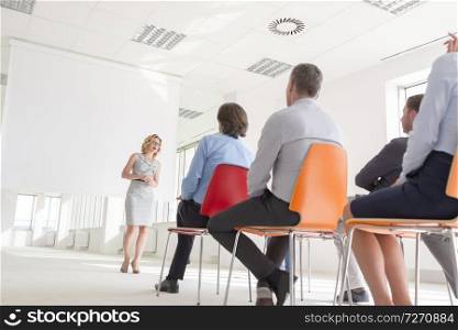 Businesswoman explaining strategy to colleagues during meeting at office