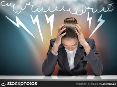 Businesswoman facing problems. Young troubled businesswoman with hands on head