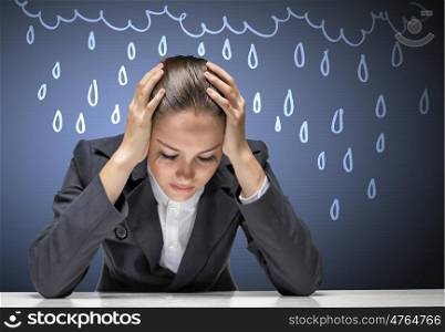 Businesswoman facing problems. Young troubled businesswoman with hands on head