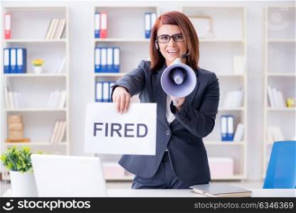 Businesswoman firing people in office