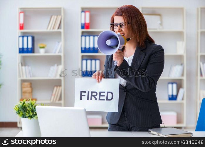 Businesswoman firing people in office