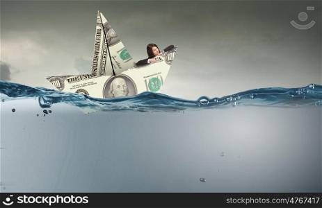 Businesswoman floating in paper ship. Concept of fake threat when businesswoman float in paper ship