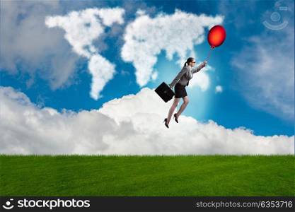 Businesswoman flying balloons on bright day