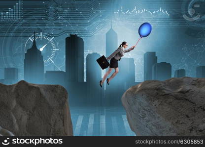 Businesswoman flying holding balloon