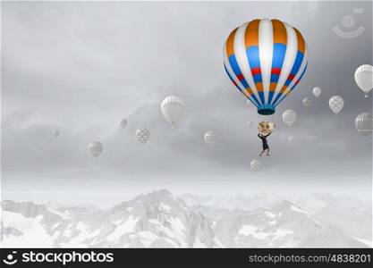 Businesswoman flying in search of ideas hanging on balloon. Search for new business ideas