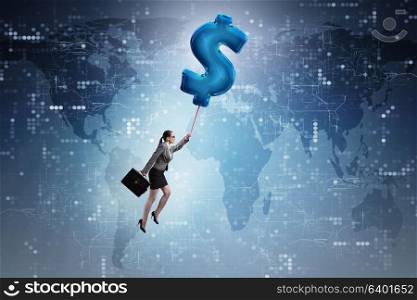 Businesswoman flying on dollar sign inflatable balloon