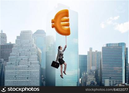 Businesswoman flying on euro sign inflatable balloon