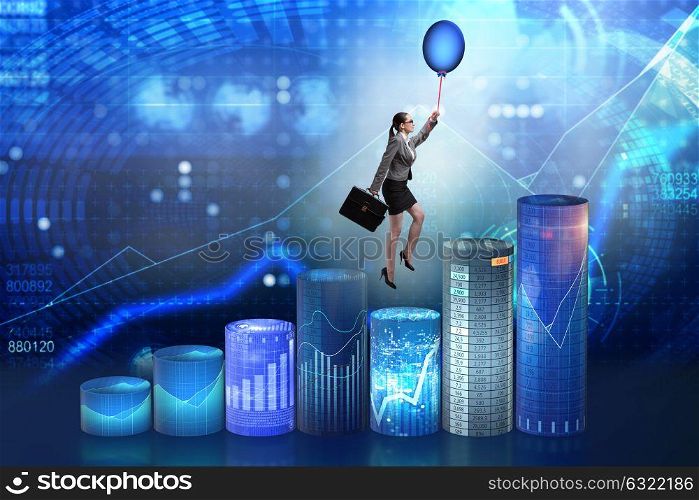 Businesswoman flying on hot balloon over graph