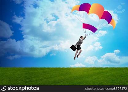 Businesswoman flying on parachute in business concept