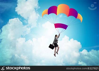 Businesswoman flying on parachute in business concept. The businesswoman flying on parachute in business concept