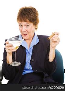 Businesswoman getting drunk at work on a martini, while smoking a cigar.