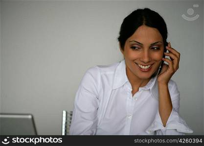 Businesswoman giggling during call
