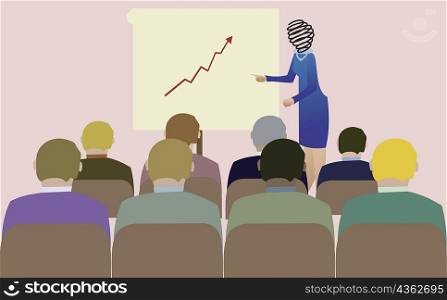 Businesswoman giving a presentation to a large group of people