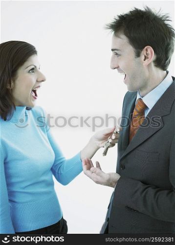 Businesswoman giving keys to a businessman