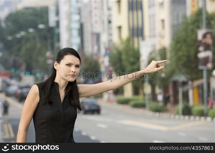 Businesswoman hailing for a vehicle