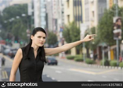 Businesswoman hailing for a vehicle