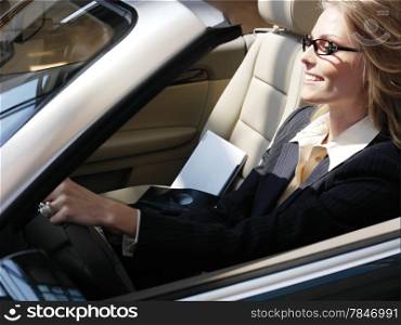 businesswoman has a fan with laptop in black car
