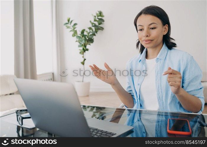 Businesswoman has group call via zoom. Young spanish woman working laptop at home office. Remote work, online meeting, discussion with team on quarantine. Business development in epidemic isolation.. Businesswoman has group call via zoom. Online meeting and business development on quarantine.
