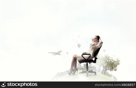 Businesswoman having rest in chair. Young relaxed businesswoman sitting relaxed in chair and dreaming