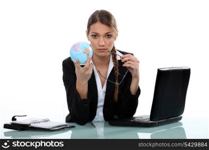 businesswoman holding a globe