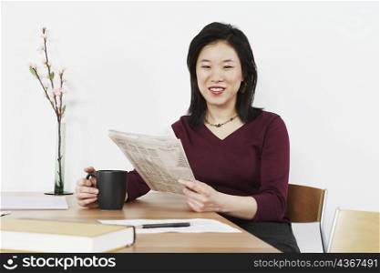 Businesswoman holding a newspaper