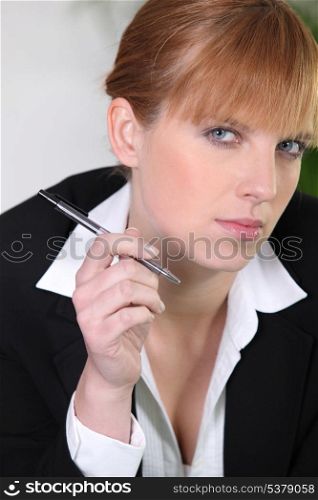 Businesswoman holding a pen