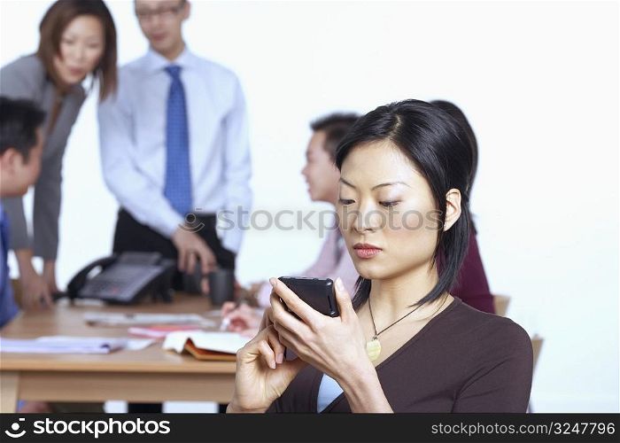 Businesswoman holding a personal data assistant