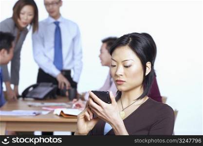 Businesswoman holding a personal data assistant