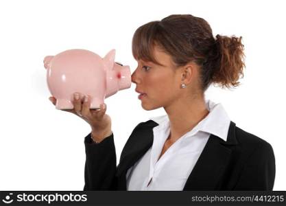 businesswoman holding a pig bank