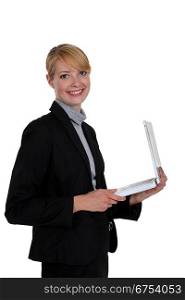 Businesswoman holding a white laptop