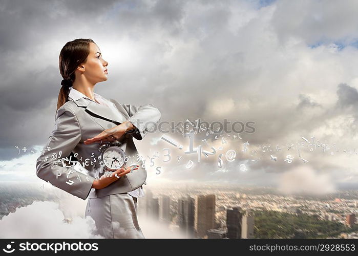 Businesswoman holding alarmclock