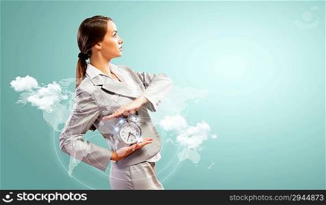 Businesswoman holding alarmclock